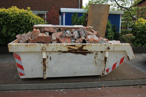 Van and crew loading garden waste outside a Wallington terraced house