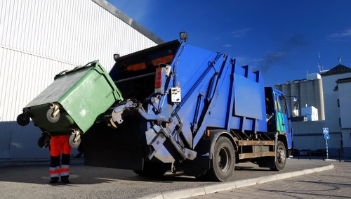 Construction workers managing builders waste clearance on site in Wallington
